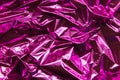 Crumpled pink foil. The background shimmers with rainbow colors Royalty Free Stock Photo