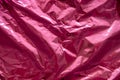 Crumpled pink foil. The background shimmers with rainbow colors Royalty Free Stock Photo