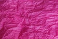 Crumpled pink magenta tissue paper for background or gift wrapping.