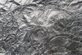 Crumpled and shiny silver paper background. Crumpled foil texture Royalty Free Stock Photo