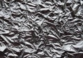 Crumpled silver aluminum foil closeup background texture. Abstract metallic paper holographic pattern Royalty Free Stock Photo