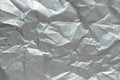 Crumpled silver matte foil texture. Abstract gray wrinkled sheet pattern, above