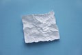 Crumpled square white checked paper sheet on on blue background