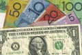 A crumpled US dollar bill over Australian money