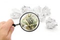 Crumpled usa dollar ball and magnifier Royalty Free Stock Photo