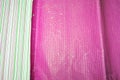 Crumpled wavy bright pink textured and colorful striped wrapping paper