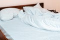 Crumpled white bedding on the bed in the bedroom Royalty Free Stock Photo