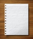 Crumpled White Notebook Paper on Wooden Surface Creating a Textured Background for Notes and Creative Writing Royalty Free Stock Photo