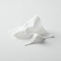 A crumpled white tissue lies on a smooth white surface. The tissue features a soft Royalty Free Stock Photo