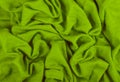 A crumpled woolen cloth. Woolen Indian Shawl. Green background of crumpled tissue