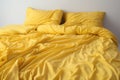 Crumpled yellow bed linen