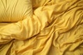 Crumpled yellow bed linen