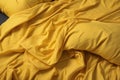 Crumpled yellow bed linen