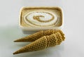 Crunchy cones with vanilla and caramel ice cream in plastic box Royalty Free Stock Photo