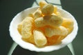 crunchy corn snacks , corn sticks with powdered sugar, contrast of sunlight and shadow.