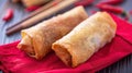 Crunchy Fried Shanghai Spring Rolls on a Red Cloth, with Chopsticks in the Background, Generative AI Royalty Free Stock Photo