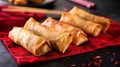 Crunchy Fried Shanghai Spring Rolls on a Red Cloth, with Chopsticks in the Background, Generative AI Royalty Free Stock Photo