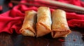 Crunchy Fried Shanghai Spring Rolls on a Red Cloth, with Chopsticks in the Background, Generative AI Royalty Free Stock Photo