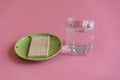 Crunchy loaves of bread and a glass of water. Concept of losing weight and healthy lifestyle