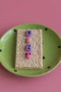 crunchy loaves of bread and a glass of water the inscription deet on a pink background. Concept of losing weight and healthy