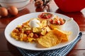 crunchy Tex Mix snacks with dip sauce served in a dish isolated on wooden background side view Royalty Free Stock Photo