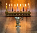 Cruse of oil made of silver, Hanukkah. with A stone menorah and candles Royalty Free Stock Photo