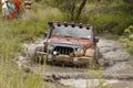 Crush Orange Jeep Rubicon crossing muddy pond Royalty Free Stock Photo