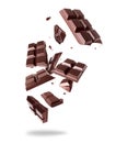 Crushed bar of dark chocolate in the air isolated on a white background Royalty Free Stock Photo