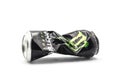 Crushed can of Monster energy drink on white background