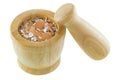 Crushed Chicken egg shells inside wooden mortar next to pestle