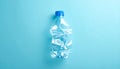 Crushed Clear Plastic Water Bottle with Blue Cap on Blue Background empty Royalty Free Stock Photo