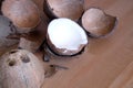 Crushed coconut shell and coconau fruit on wooden background