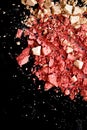 Crushed cosmetics, mineral organic eyeshadow, blush and cosmetic powder isolated on black background, makeup and beauty Royalty Free Stock Photo