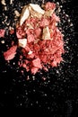 Crushed cosmetics, mineral organic eyeshadow, blush and cosmetic powder isolated on black background, makeup and beauty Royalty Free Stock Photo