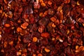 Crushed dried chili pepper red background, close-up macro. Concept, copy space Royalty Free Stock Photo