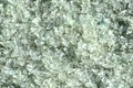 Crushed small pieces of glass are gathered for recycling in a machine in a recycling facility. Royalty Free Stock Photo