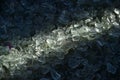 Crushed small pieces of glass are gathered for recycling in a machine in a recycling facility. Royalty Free Stock Photo