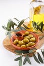 Crushed green olives in bowl on white table. Close-up Royalty Free Stock Photo