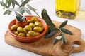 Crushed green olives in bowl on white table. Close-up Royalty Free Stock Photo