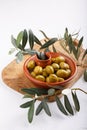 Crushed green olives in bowl on white table. Close-up Royalty Free Stock Photo