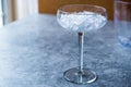 Crushed Ice in Cocktail Glass on Blue Surface. Royalty Free Stock Photo