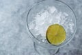Crushed Ice in Cocktail Glass with Lime on Blue Surface. Royalty Free Stock Photo