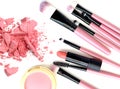 Crushed make up powder and lipstick samples with brushes on white background. Royalty Free Stock Photo
