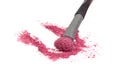 Crushed pink rouge eyeshadow cosmetic product and makeup brush isolated on the white background Royalty Free Stock Photo