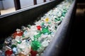 crushed plastic bottles on a conveyor belt at a recycling plant Royalty Free Stock Photo