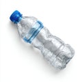 Crushed plastic water bottle with blue cap on white background Royalty Free Stock Photo