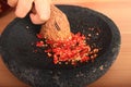 Crushed red chilli paprikas in mortar Royalty Free Stock Photo