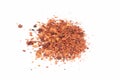 Pile crushed red cayenne pepper, dried chili flakes and seeds isolated on bright background.