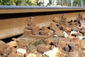 The crushed stones or ballast alongside the rail track hold the wooden cross ties in place, which in turn lock the i