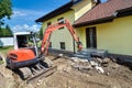 A crusher is demolishing a house